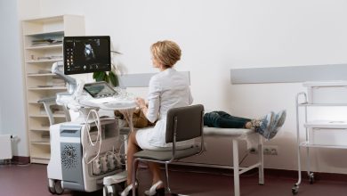 Médica realiza exame de ultrassonografia em uma paciente dentro de uma clínica.
